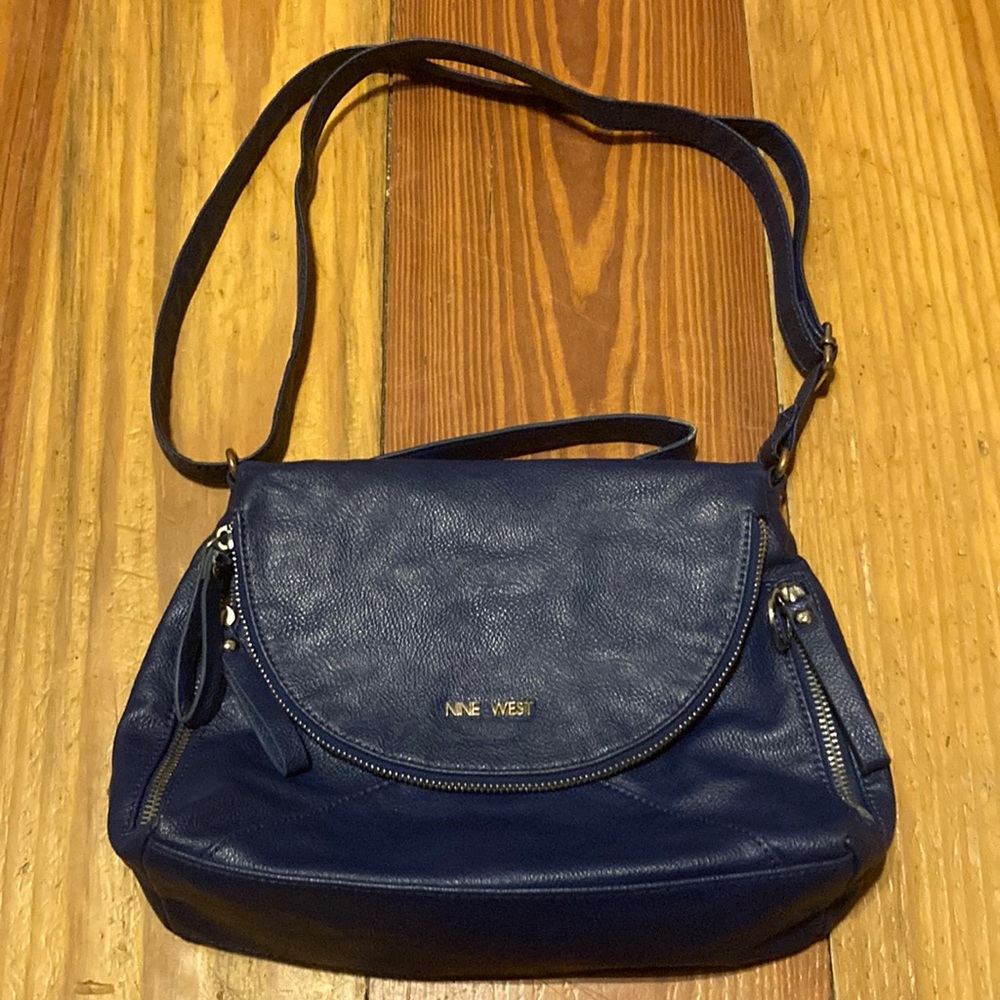 Nine West blue purse with zippers and handle does show wear and tear